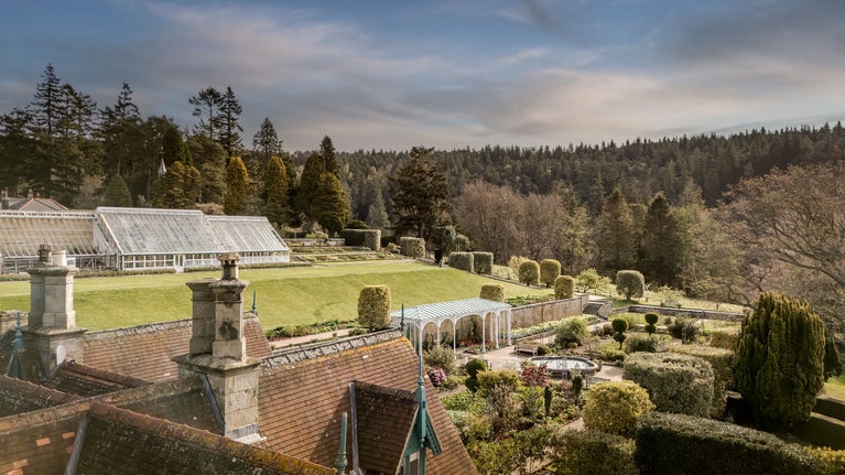 A view across the roof of Cragside Garden Cottage to the formal gardens, Northumberland